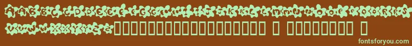 フォントFriedEggsSmallcaps – 緑色の文字が茶色の背景にあります。