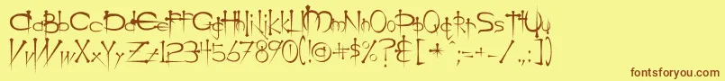 フォントOgilviec – 茶色の文字が黄色の背景にあります。