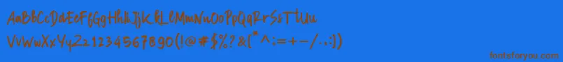 フォントManksa – 茶色の文字が青い背景にあります。