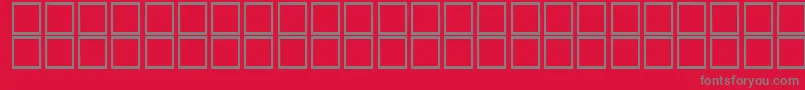 フォントKufiBold – 赤い背景に灰色の文字