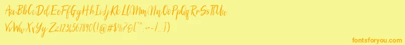 フォントSilhouettoScript – オレンジの文字が黄色の背景にあります。