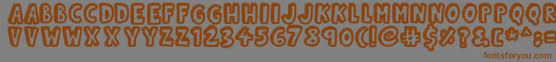 フォントKinda3D – 茶色の文字が灰色の背景にあります。