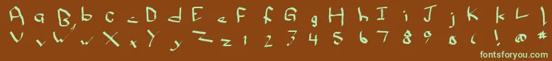 フォントQwikscribblenormal – 緑色の文字が茶色の背景にあります。