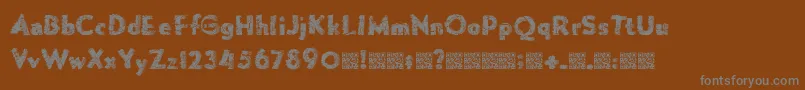 フォントForgemelt – 茶色の背景に灰色の文字