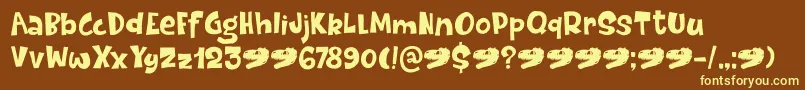 DinosaurCakeDemo-fontti – keltaiset fontit ruskealla taustalla