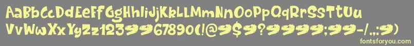 DinosaurCakeDemo-fontti – keltaiset fontit harmaalla taustalla