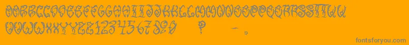 VtcTribalthreefree-Schriftart – Graue Schriften auf orangefarbenem Hintergrund