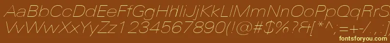 UniversNextProUltralightExtendedItalic-fontti – keltaiset fontit ruskealla taustalla