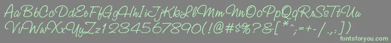 Studioscriptbtt-Schriftart – Grüne Schriften auf grauem Hintergrund