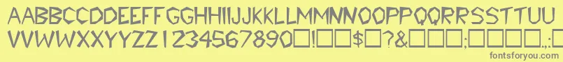 TribaldisplaycapssskRegular-fontti – harmaat kirjasimet keltaisella taustalla