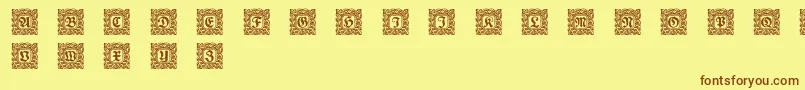 フォントSchmuckinitialen2 – 茶色の文字が黄色の背景にあります。