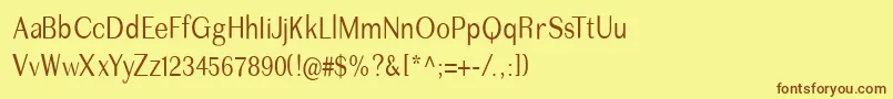 フォントImperiumcond – 茶色の文字が黄色の背景にあります。