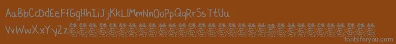 LaurencbDemo-Schriftart – Graue Schriften auf braunem Hintergrund