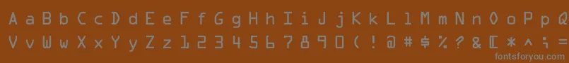 MicroscanA-fontti – harmaat kirjasimet ruskealla taustalla