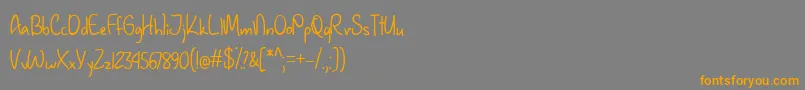フォントJanuaryHandwritingTtf – オレンジの文字は灰色の背景にあります。
