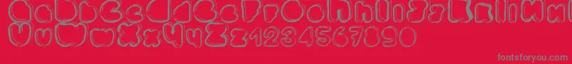 Ponctuation-fontti – harmaat kirjasimet punaisella taustalla