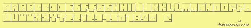 フォントOkiExtrude – 黄色の背景に灰色の文字