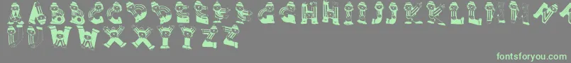 Clownsalphabeta-Schriftart – Grüne Schriften auf grauem Hintergrund