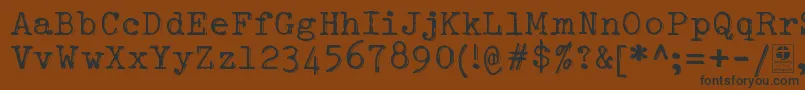 フォントTypowriterShakyDemo – 黒い文字が茶色の背景にあります