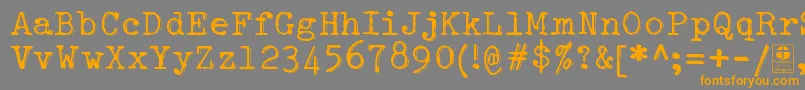 フォントTypowriterShakyDemo – オレンジの文字は灰色の背景にあります。