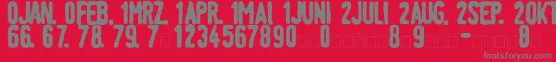 LinotypeTagesstempelFett-fontti – harmaat kirjasimet punaisella taustalla