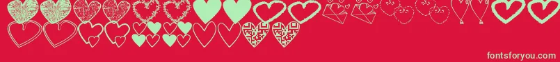 HeartsShapessTfb-Schriftart – Grüne Schriften auf rotem Hintergrund