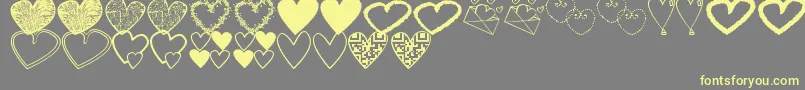 HeartsShapessTfb-Schriftart – Gelbe Schriften auf grauem Hintergrund