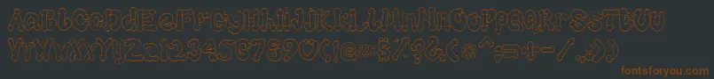 Cocksure-fontti – ruskeat fontit mustalla taustalla