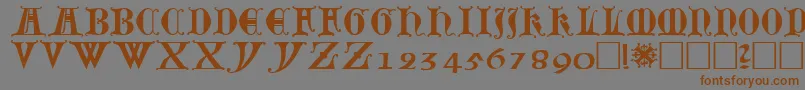 フォントLubeck0 – 茶色の文字が灰色の背景にあります。