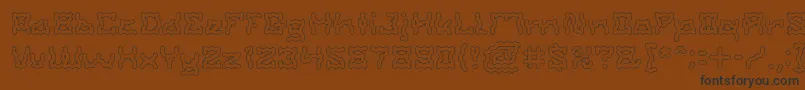 ShakeItOffHolow-Schriftart – Schwarze Schriften auf braunem Hintergrund
