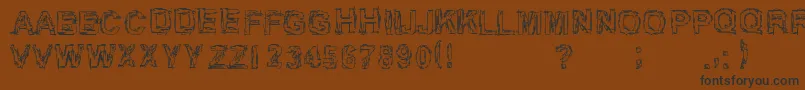 フォントInch75 – 黒い文字が茶色の背景にあります