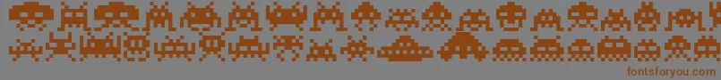 フォントInvaders – 茶色の文字が灰色の背景にあります。