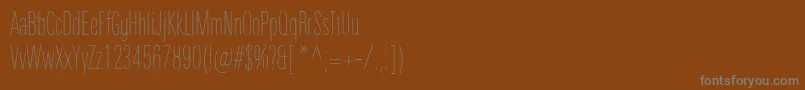 Fonte UniversNextProUltralightCompressed – fontes cinzas em um fundo marrom