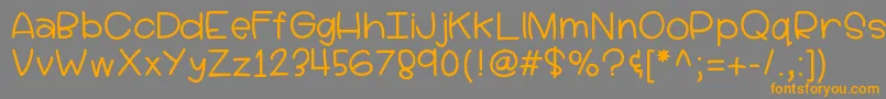 フォントHellolucy – オレンジの文字は灰色の背景にあります。