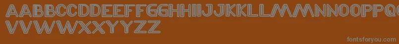 LaserGun-fontti – harmaat kirjasimet ruskealla taustalla