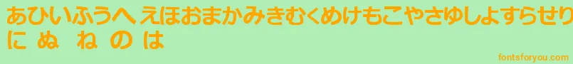 フォントHiraganaTfb – オレンジの文字が緑の背景にあります。