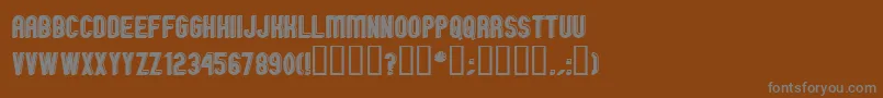 GmExpOffsetOutline-fontti – harmaat kirjasimet ruskealla taustalla
