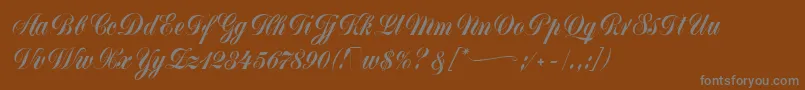 Fonte MonikaScript – fontes cinzas em um fundo marrom