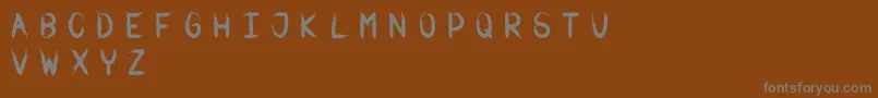 Warbrushフォントについての詳細 フォントWarbrush – 茶色の背景に灰色の文字