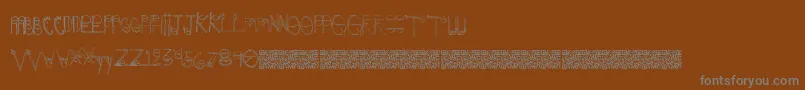Crazyeyes-fontti – harmaat kirjasimet ruskealla taustalla