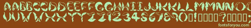 フォントJungleleaves – 緑色の文字が茶色の背景にあります。