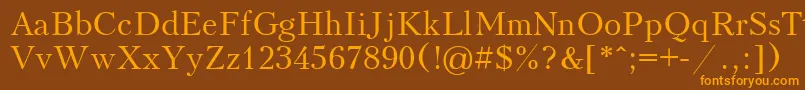 フォントUkrainiankudriashov – オレンジ色の文字が茶色の背景にあります。