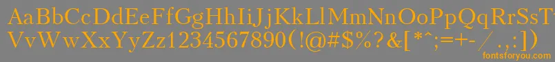 フォントUkrainiankudriashov – オレンジの文字は灰色の背景にあります。