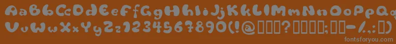Flattyre-fontti – harmaat kirjasimet ruskealla taustalla