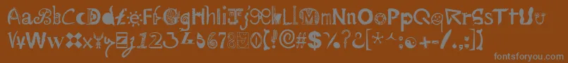 Mailart ffy-fontti – harmaat kirjasimet ruskealla taustalla