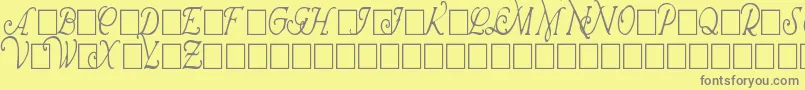 WrennInitialsCondensed-fontti – harmaat kirjasimet keltaisella taustalla