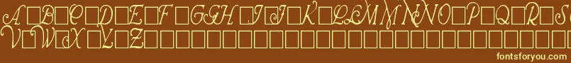 WrennInitialsCondensed-fontti – keltaiset fontit ruskealla taustalla
