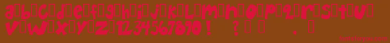 フォントHappyHero – 赤い文字が茶色の背景にあります。