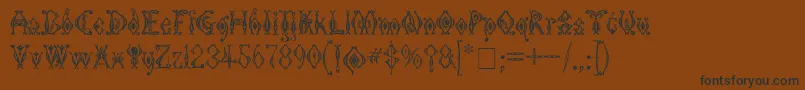 KingthingsTendrylle-Schriftart – Schwarze Schriften auf braunem Hintergrund