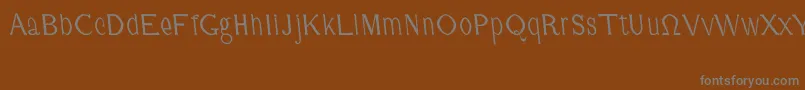CmFunnyRegular-fontti – harmaat kirjasimet ruskealla taustalla